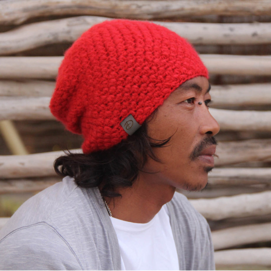 Man wearing KARO red beanie