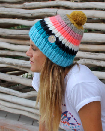 Woman wearing RAINBOW adults coral beanie